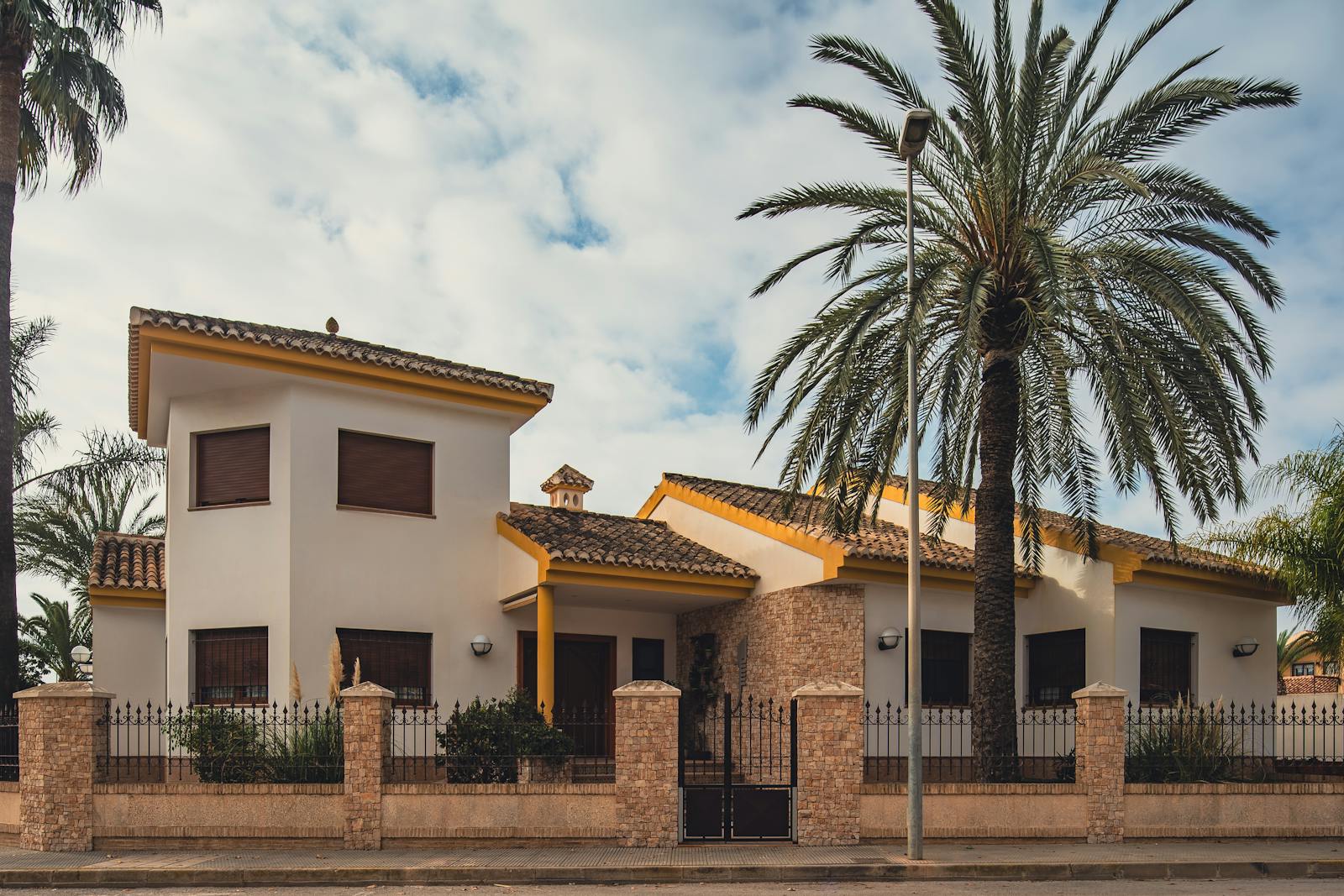 Mediterranean villa in Spain with palm trees and traditional architecture
